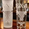 Texas Longhorn Heritage engraved tequila shot glasses displayed on bar counter